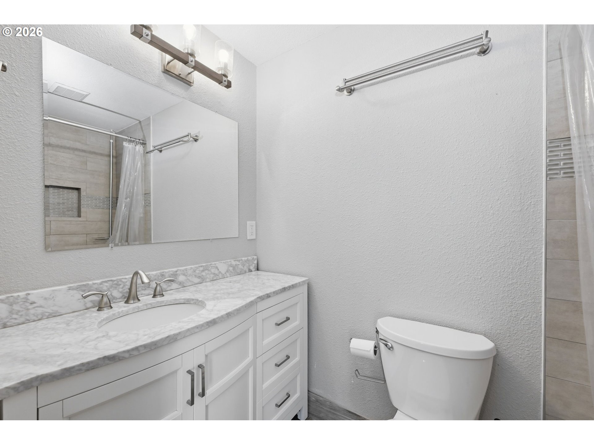 2612 Sage Street Eugene, OR 97404 - Photo 23 of 45 a bathroom with a granite countertop sink toilet a mirror a vanity and shower