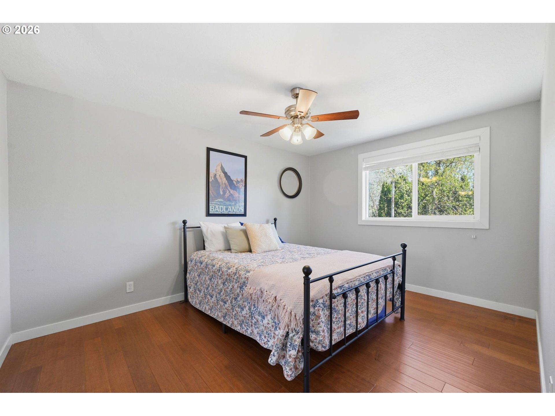 2612 Sage Street Eugene, OR 97404 - Photo 27 of 45 a bedroom with a bed chandelier and a window