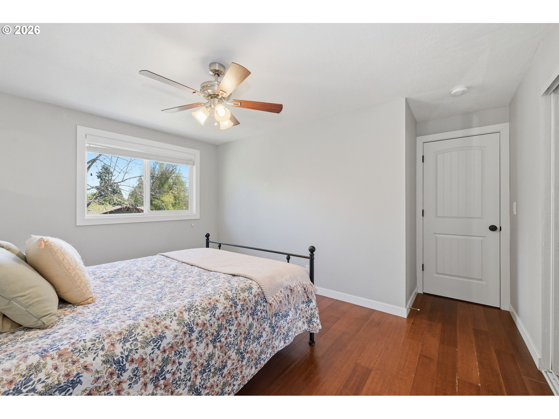 2612 Sage Street Eugene, OR 97404 - Photo 28 of 45 a bedroom with a large bed and a chandelier