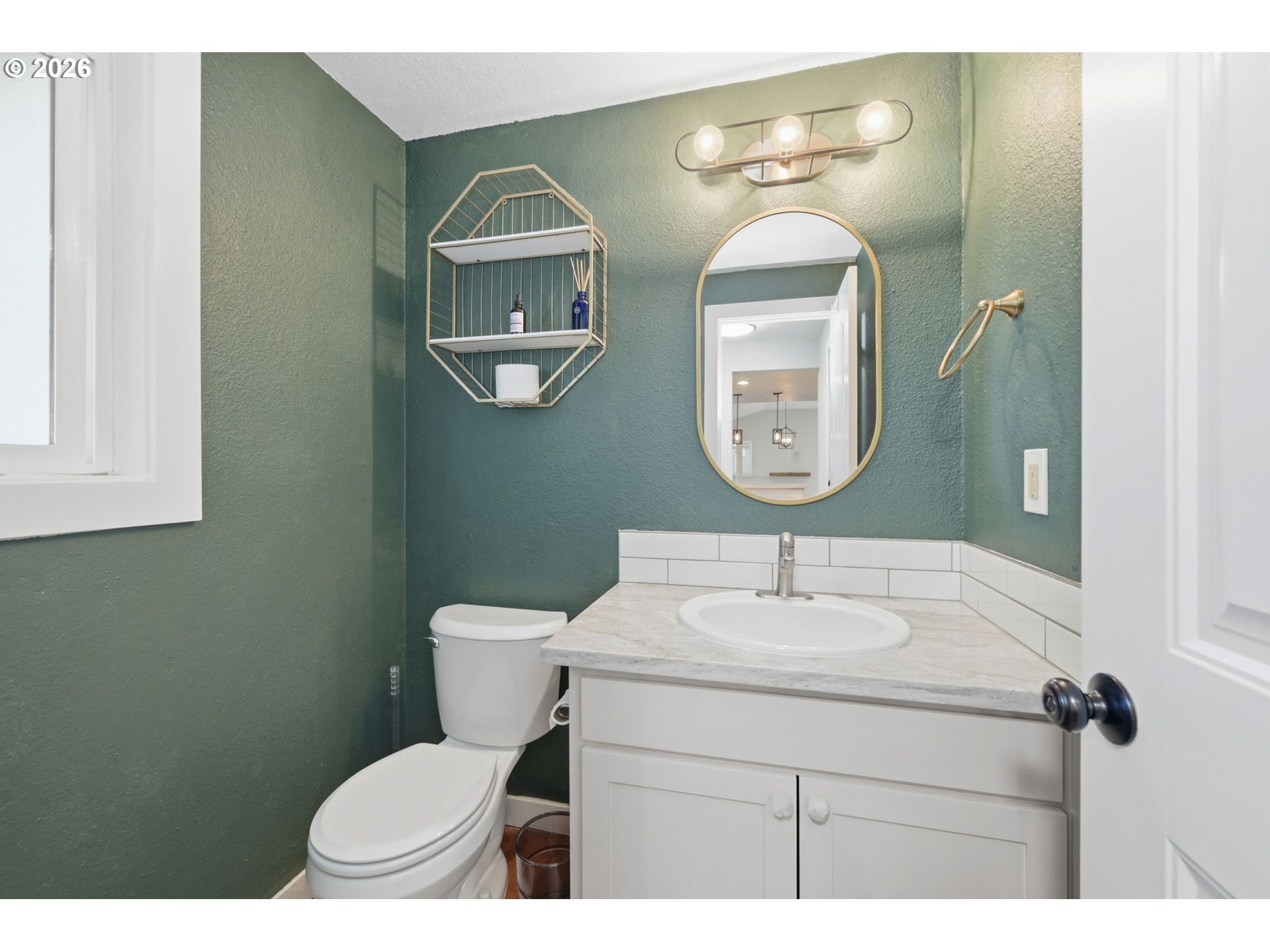 2612 Sage Street Eugene, OR 97404 - Photo 31 of 45 a bathroom with a toilet sink and mirror