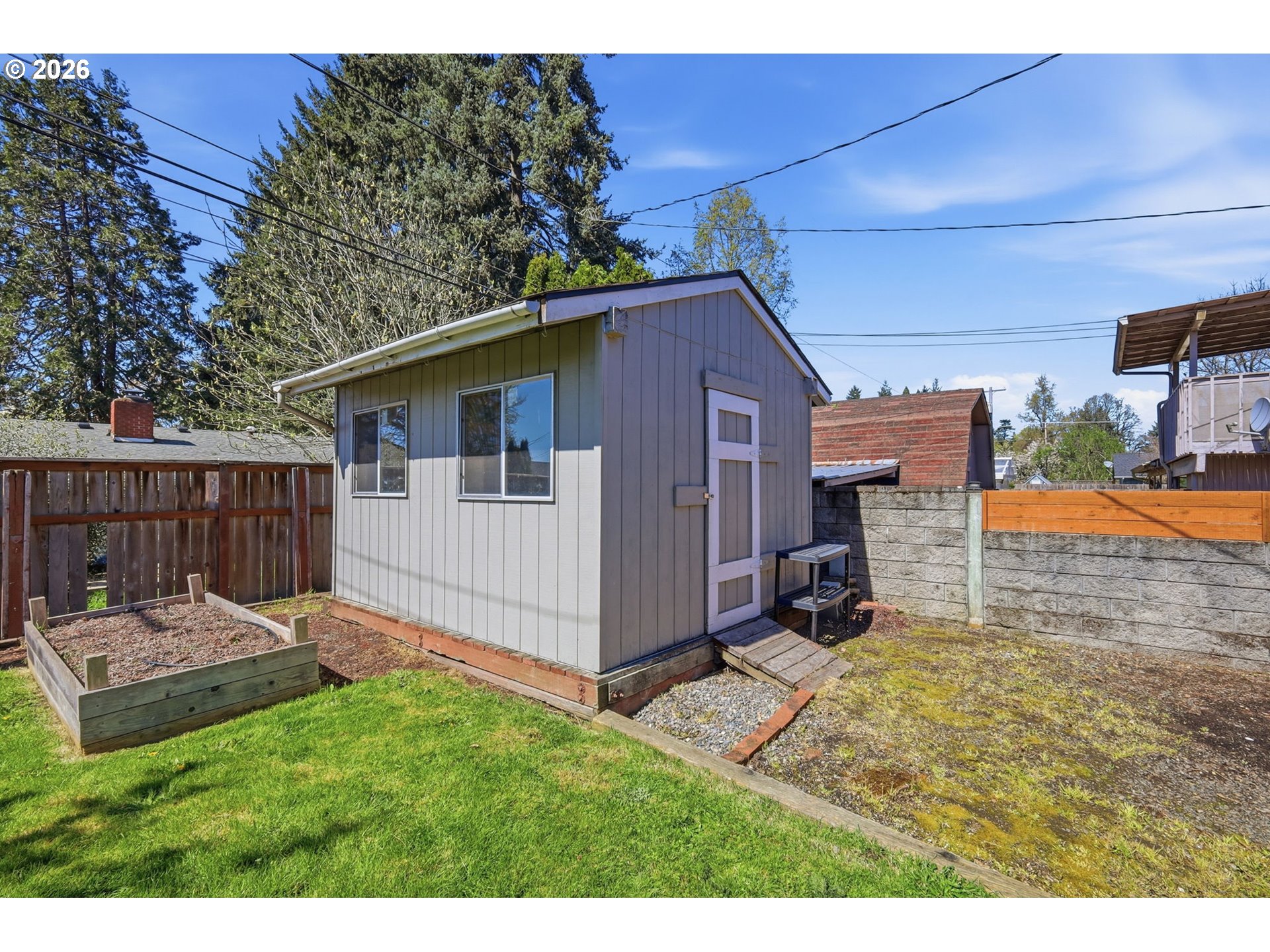 2612 Sage Street Eugene, OR 97404 - Photo 36 of 45 a view of a small house with a small yard and wooden fence