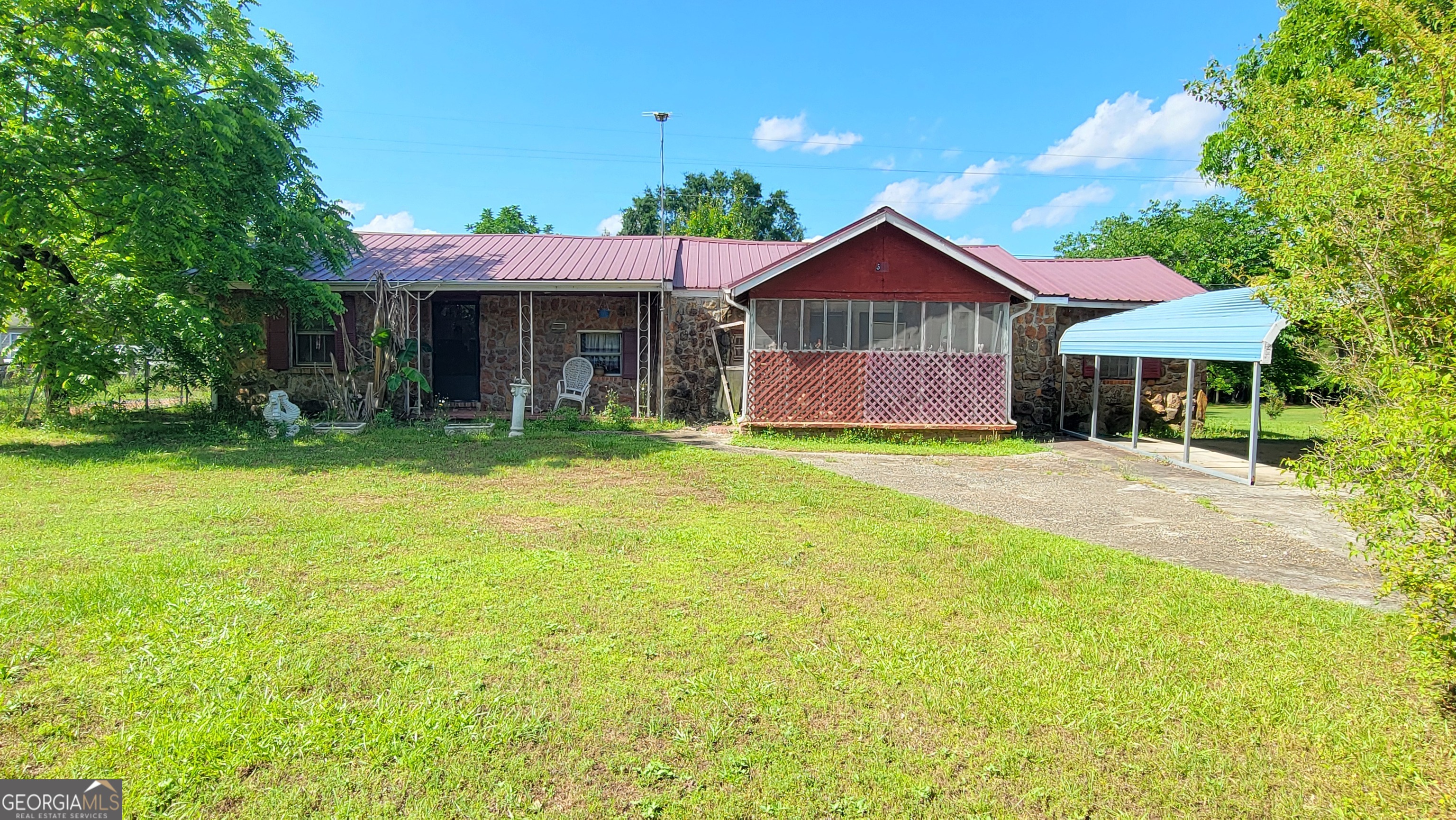 a front view of a house with yard and glass top table