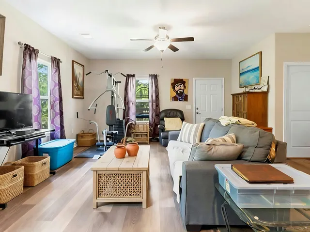 a living room with furniture a rug and a flat screen tv