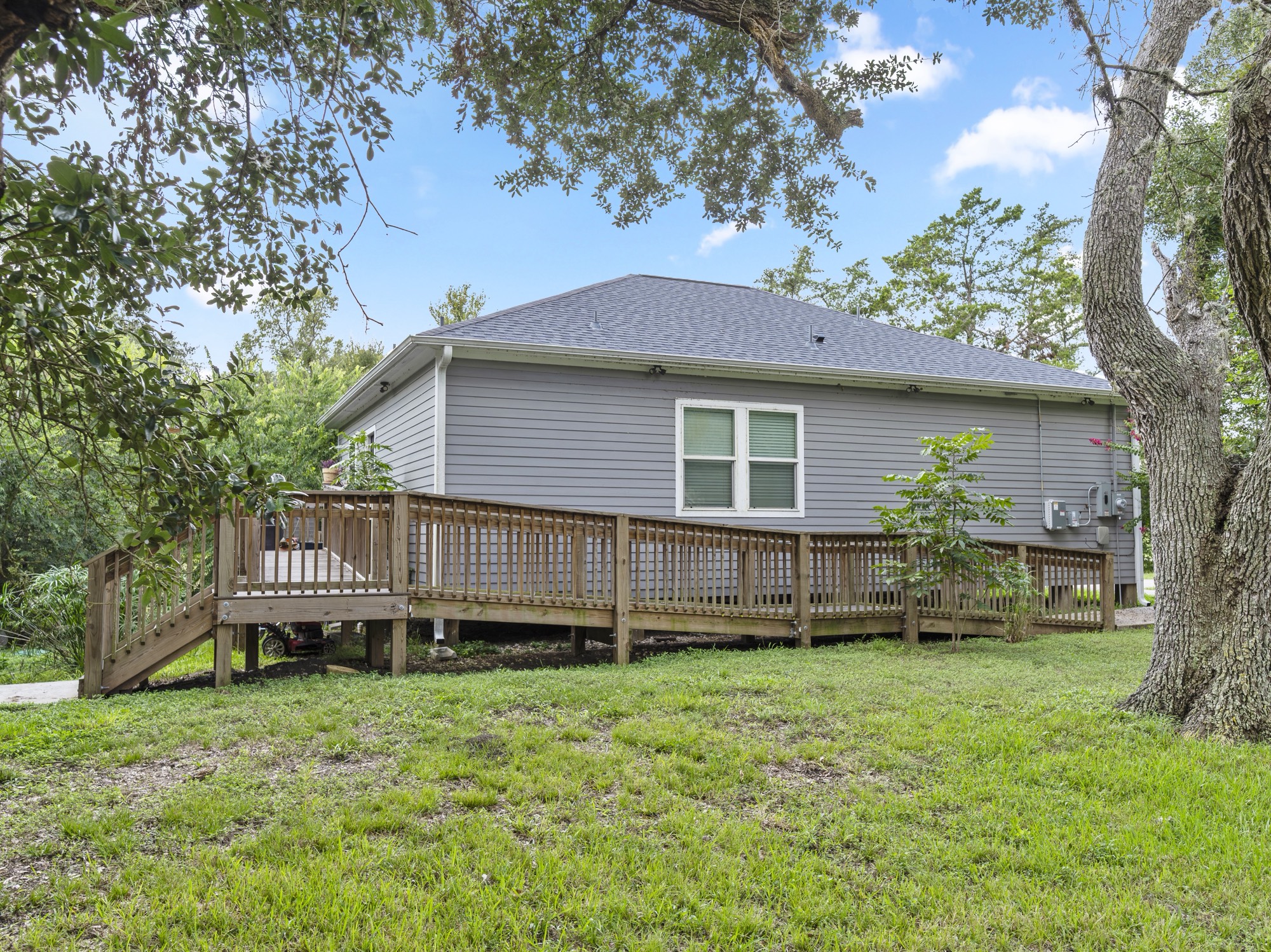 334 Old River Road North Palacios, TX 77465 - Photo 3 of 15 a view of a house with a backyard and a wooden deck