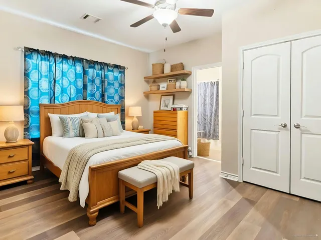 a bedroom with a large bed and a chandelier