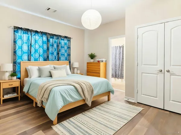 a bedroom with a large bed and a window