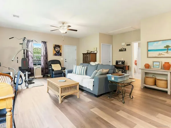 a living room with furniture and a wooden floor