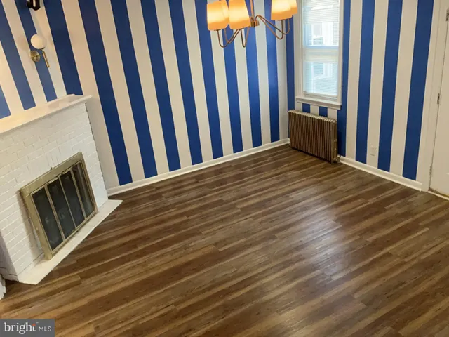 a view of wooden floor and windows in a room