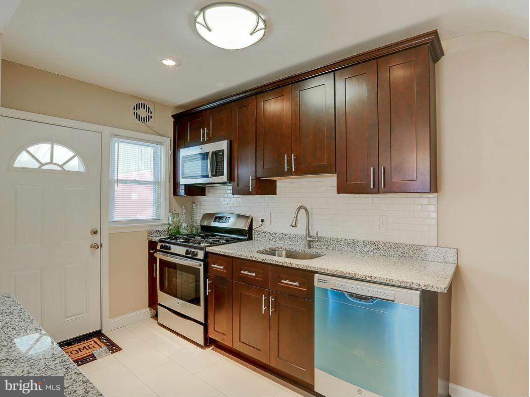 51 Hawthorne Road Middle River, MD 21220 - Photo 3 of 30 a kitchen with stainless steel appliances granite countertop a sink stove and microwave