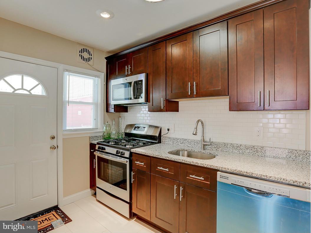 51 Hawthorne Road Middle River, MD 21220 - Photo 4 of 30 a kitchen with a sink stove top oven and cabinets