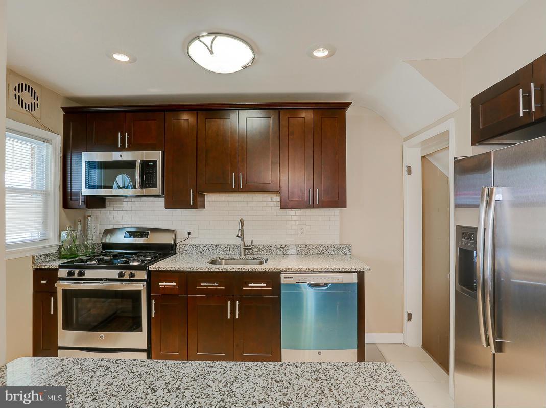 51 Hawthorne Road Middle River, MD 21220 - Photo 7 of 30 a kitchen with stainless steel appliances granite countertop a stove a sink and a microwave