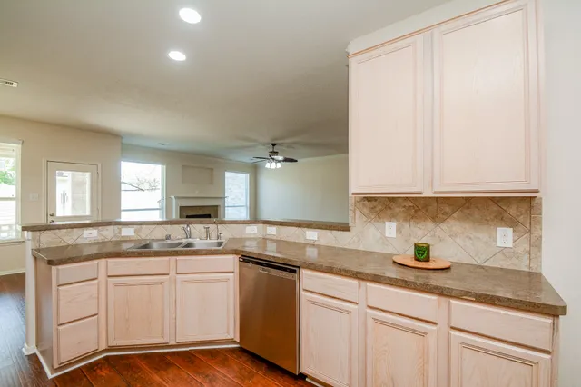 a kitchen with granite countertop white cabinets and white appliances