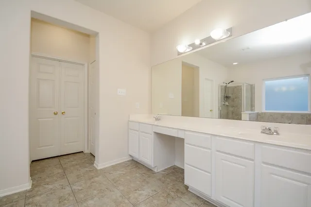 a spacious bathroom with a sink a mirror and a vanity