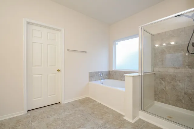 a bathroom with a bathtub and a shower