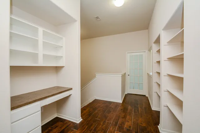 a view of walk in closet with empty racks