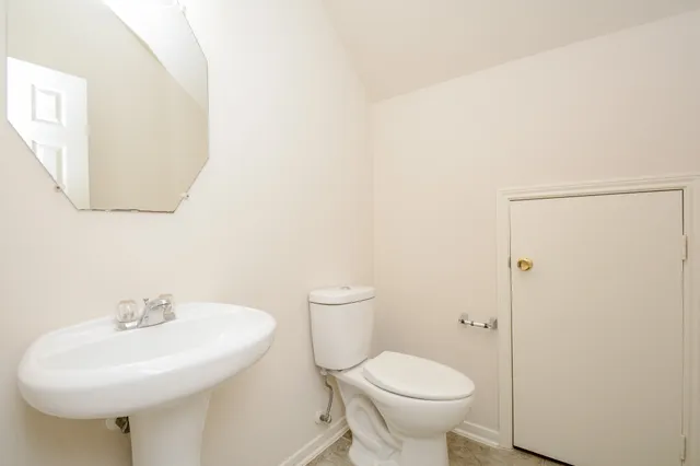a bathroom with a sink a toilet and mirror