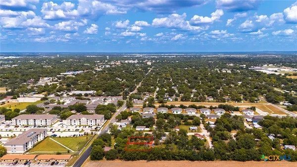 an aerial view of residential building with yard