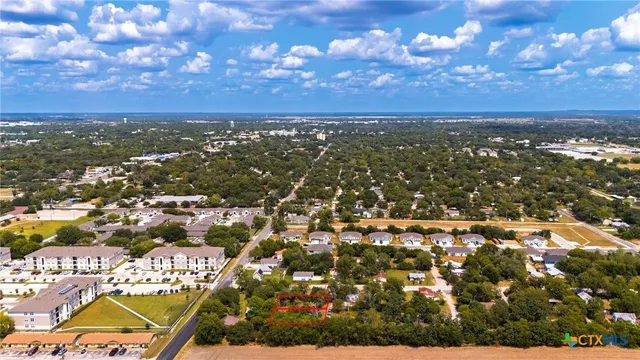 an aerial view of residential building with yard