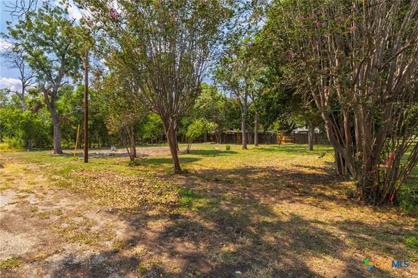 a view of yard with tree and trees