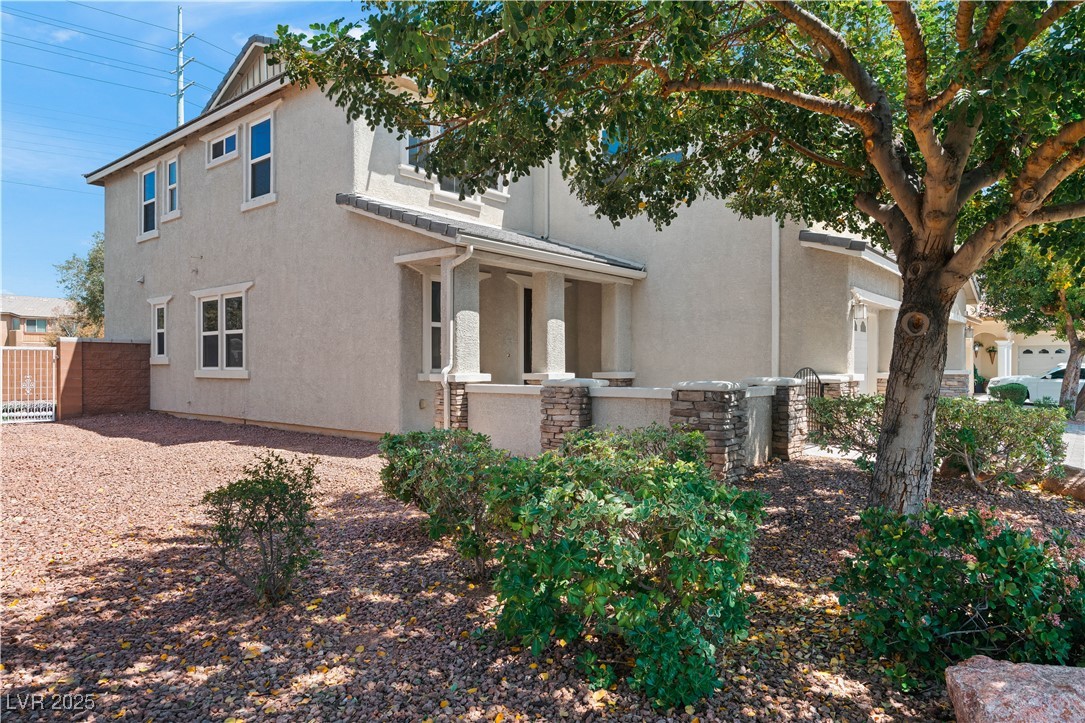 312 Pocono Ranch Avenue North Las Vegas, NV 89031 - Photo 33 of 34 View of home's exterior featuring fence, stucco siding, and stone siding