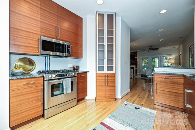 a kitchen with stainless steel appliances granite countertop a stove and a microwave