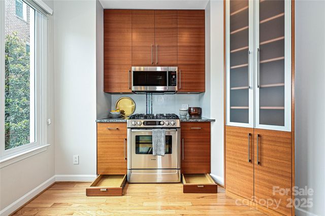 a living room with stainless steel appliances kitchen island granite countertop furniture and a kitchen view