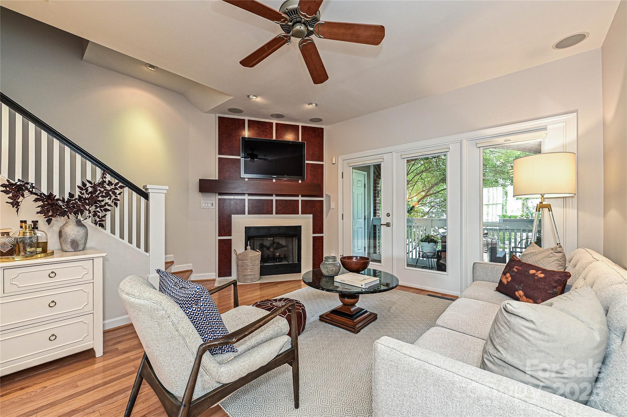 333 West 7th Street Charlotte, NC 28202 - Photo 18 of 46 a living room with furniture a fireplace and a flat screen tv
