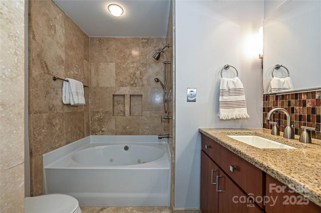 a bathroom with a shower and a toilet
