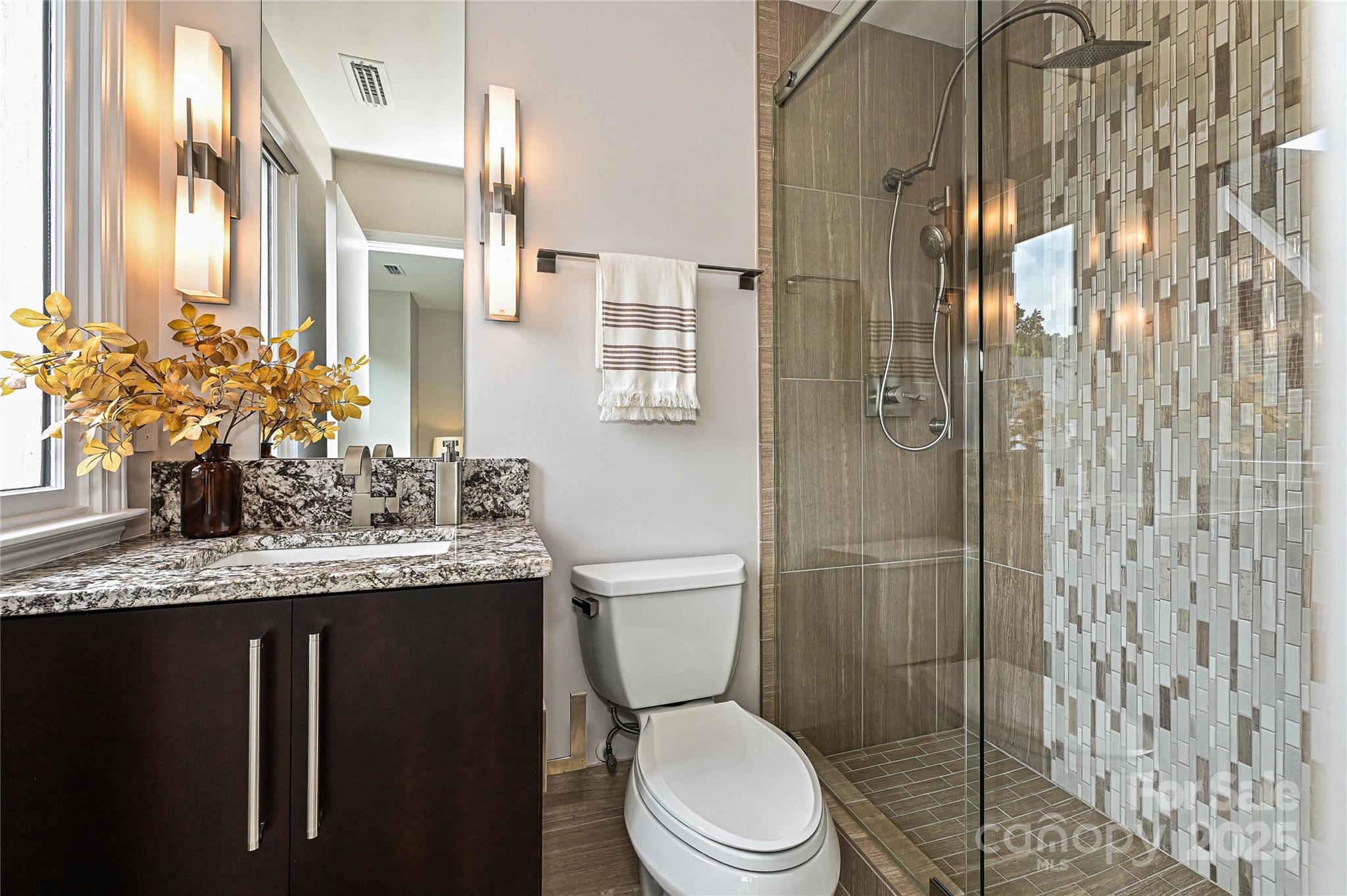 333 West 7th Street Charlotte, NC 28202 - Photo 33 of 46 a bathroom with a granite countertop sink a toilet and shower