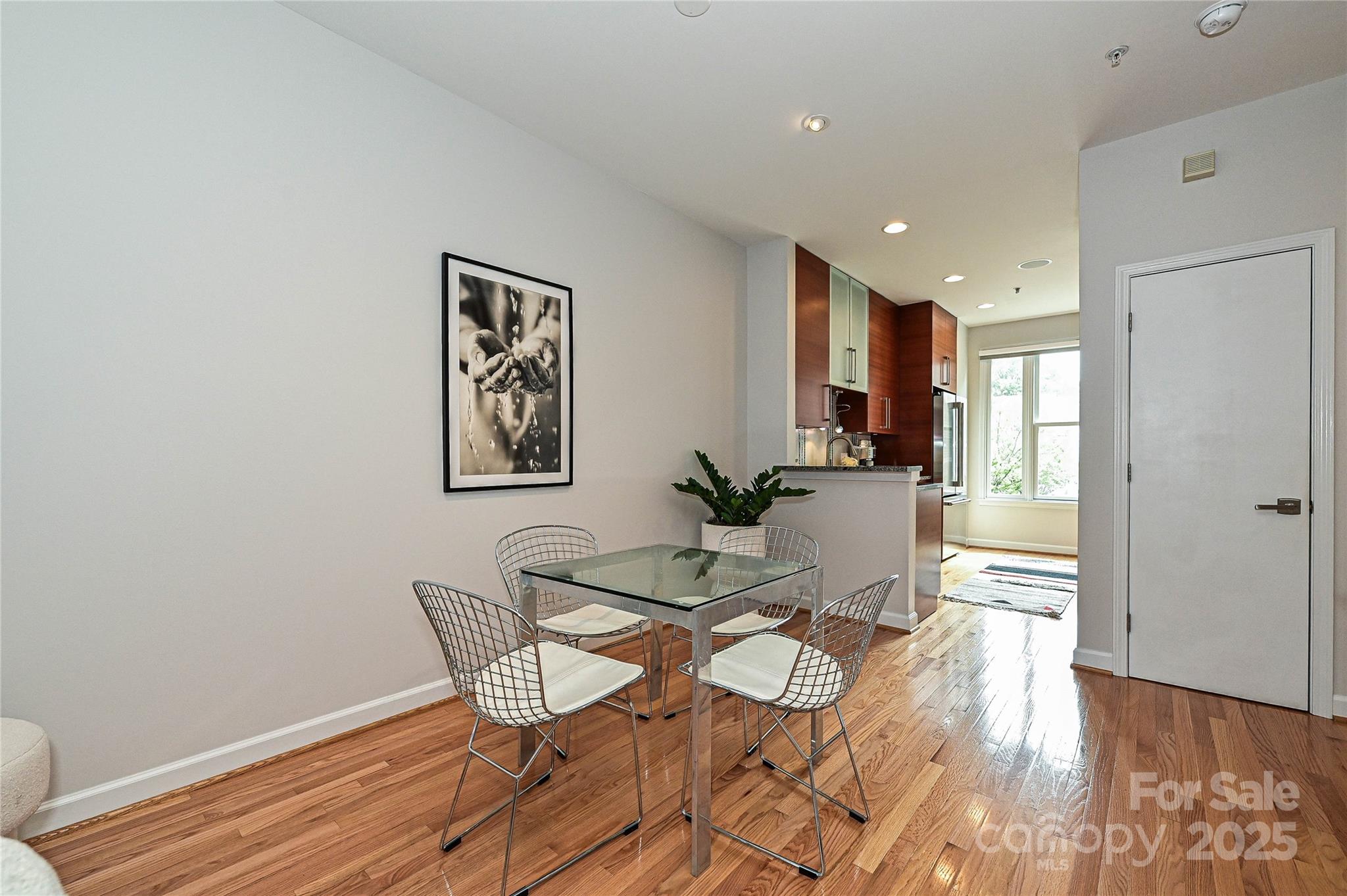 333 West 7th Street Charlotte, NC 28202 - Photo 7 of 46 a view of a dining room with furniture and wooden floor