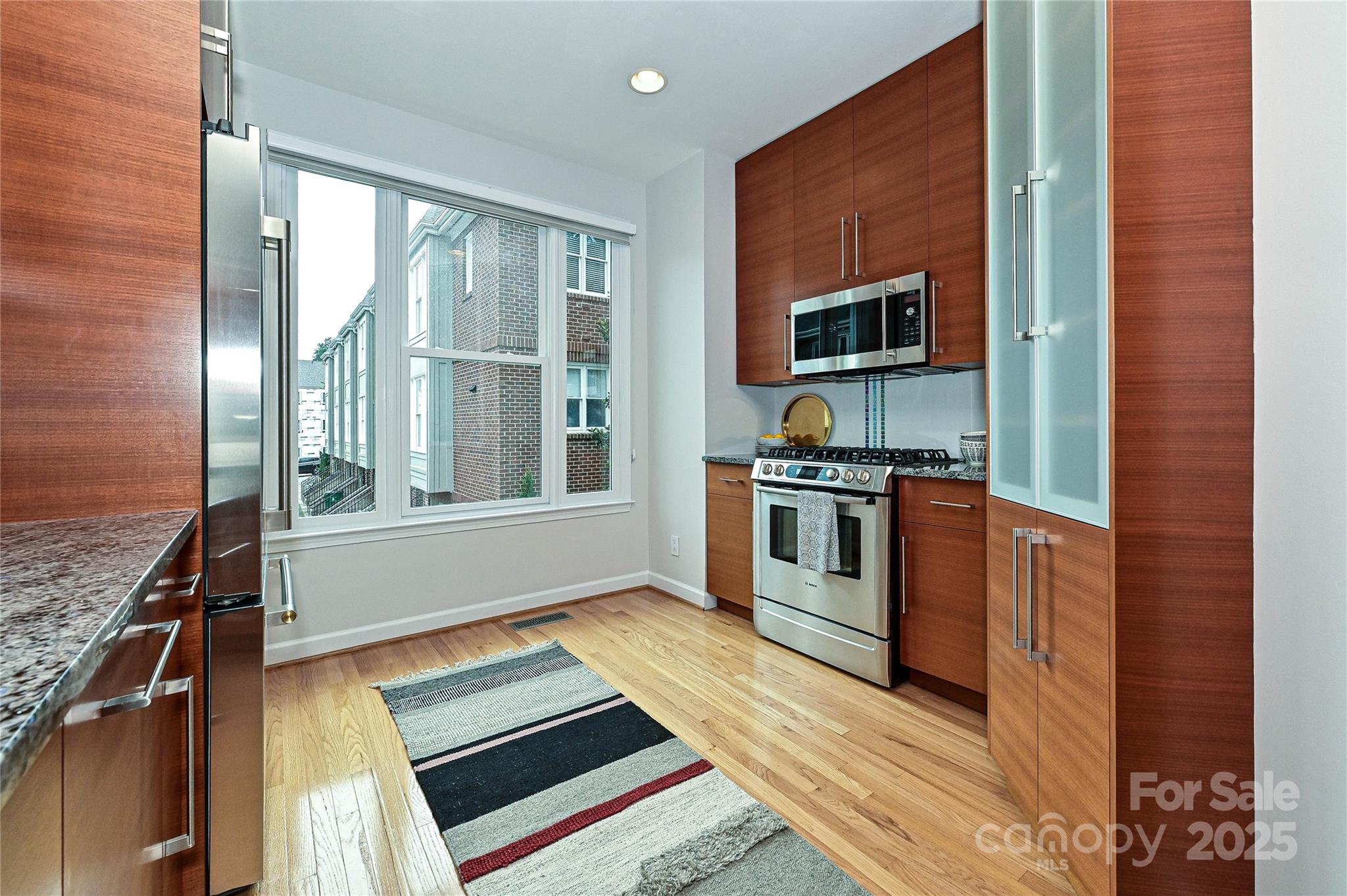 333 West 7th Street Charlotte, NC 28202 - Photo 9 of 46 a kitchen with stainless steel appliances granite countertop a stove and a sink