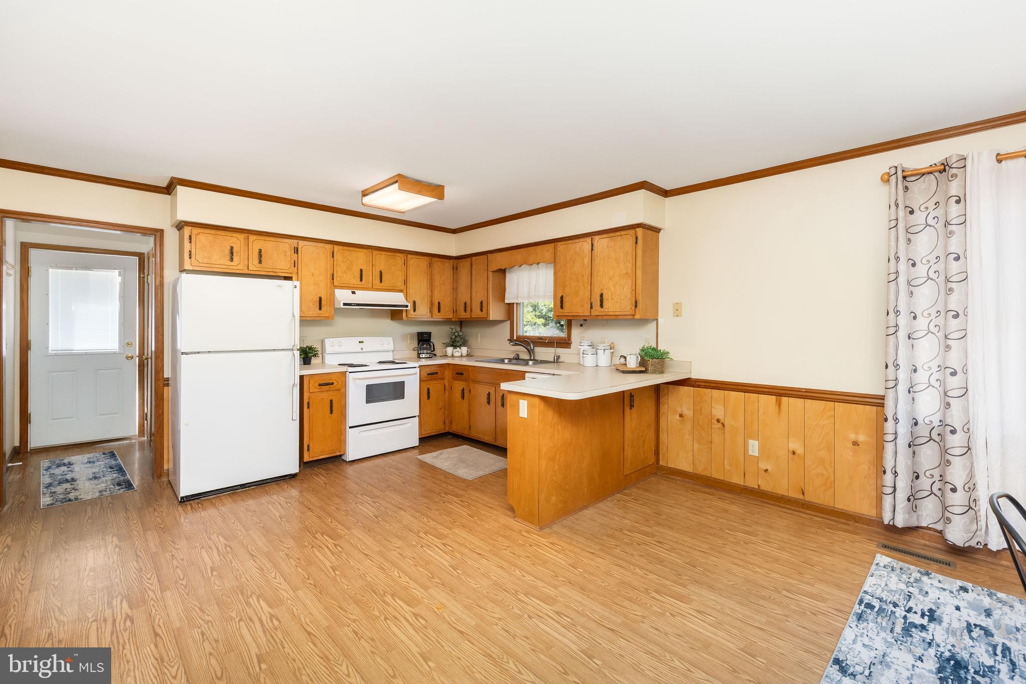 9830 Sharptown Road Mardela Springs, MD 21837 - Photo 5 of 51 a kitchen with a refrigerator a sink and cabinets