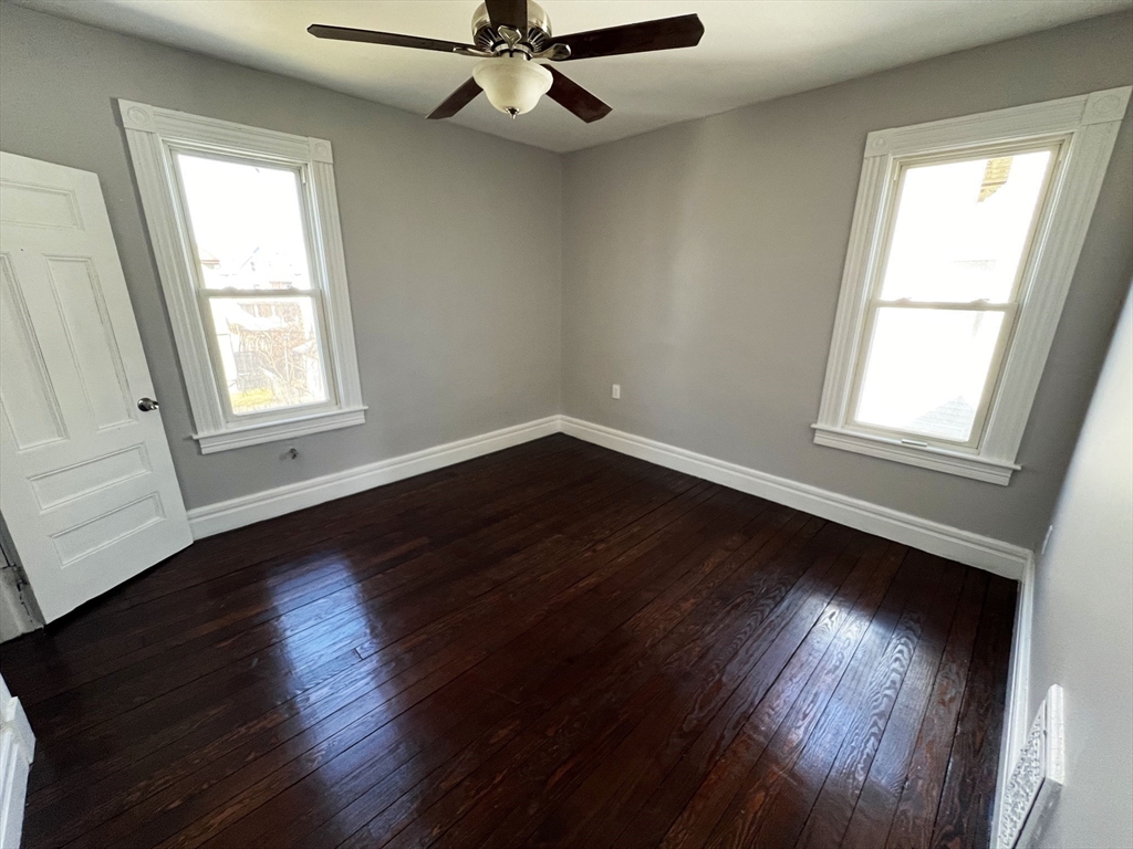 24 Wareham Street Springfield, MA 01108 - Photo 4 of 16 a view of an empty room with wooden floor and a window