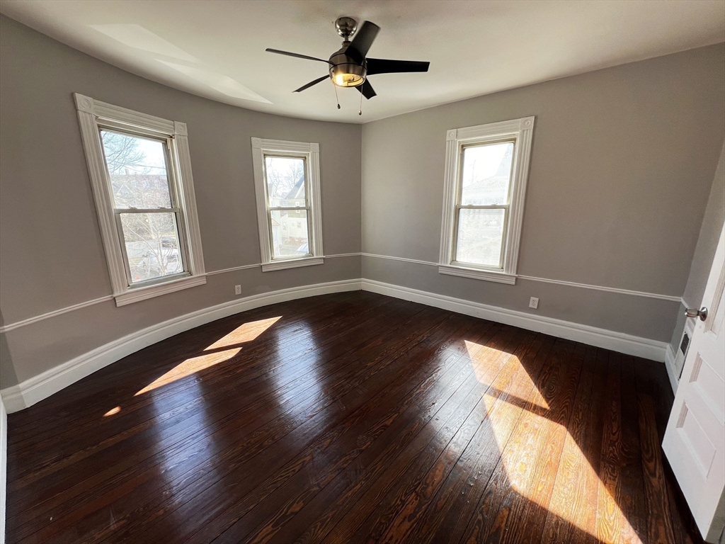 24 Wareham Street Springfield, MA 01108 - Photo 5 of 16 a view of empty room with wooden floor and fan