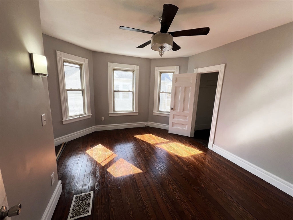 24 Wareham Street Springfield, MA 01108 - Photo 6 of 16 a view of empty room with wooden floor and fan