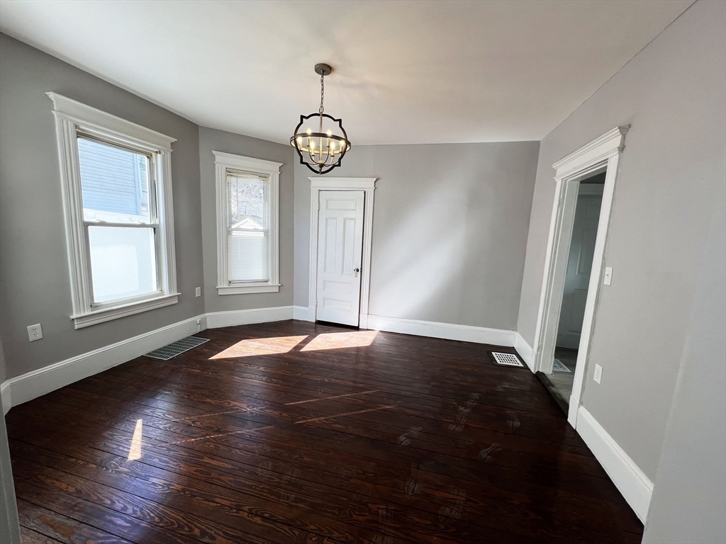 24 Wareham Street Springfield, MA 01108 - Photo 7 of 16 an empty room with wooden floor and windows