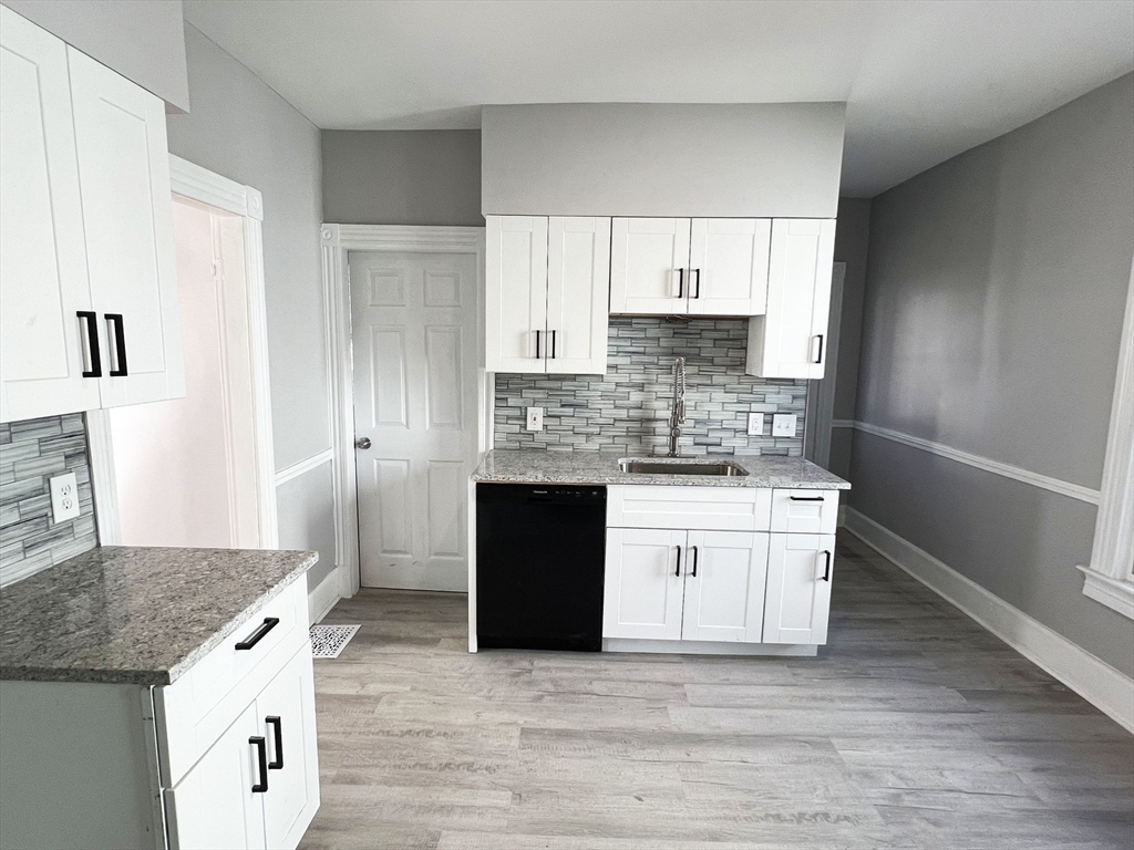 24 Wareham Street Springfield, MA 01108 - Photo 8 of 16 a kitchen with stainless steel appliances granite countertop a stove and a refrigerator