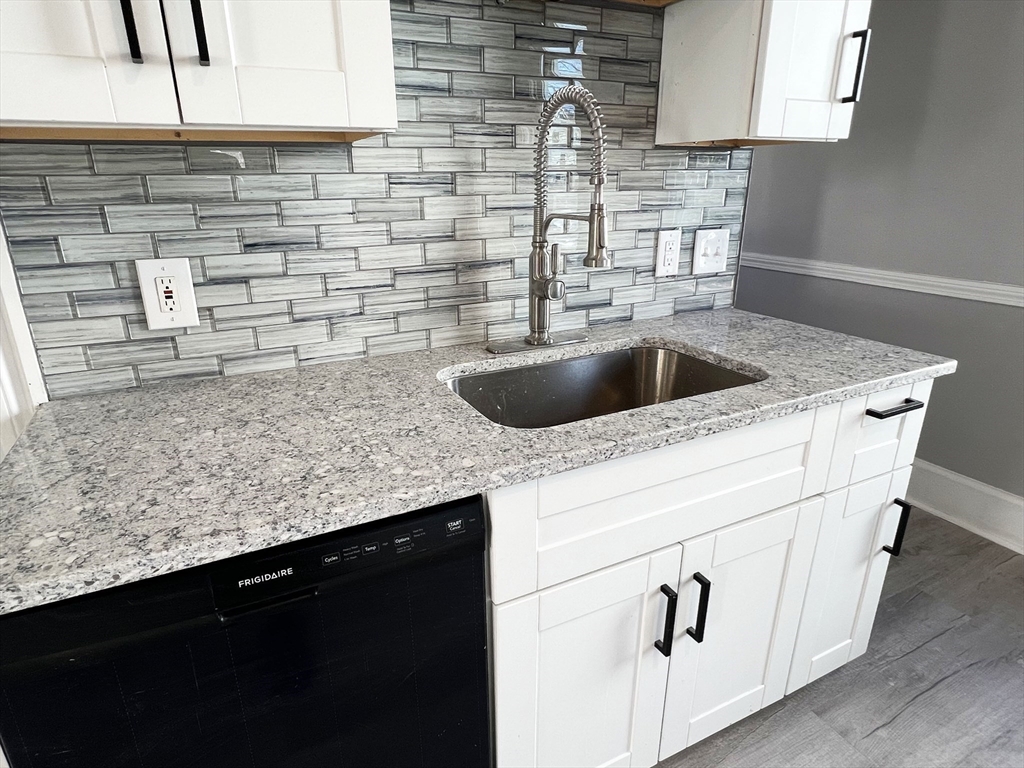 24 Wareham Street Springfield, MA 01108 - Photo 10 of 16 a kitchen with a sink a stove and cabinets