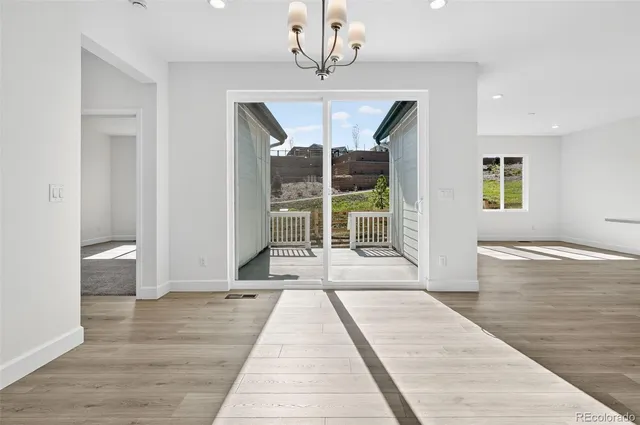 a view of a room with wooden floor and windows