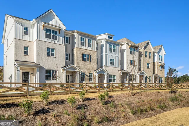 a front view of a residential apartment building with a yard