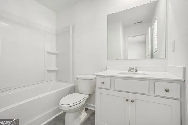 a bathroom with a sink toilet vanity and tub