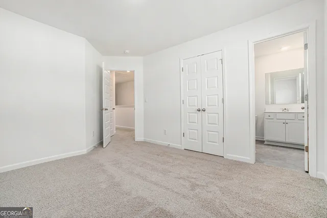 an empty room with a bathroom and a sink
