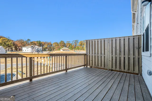 a balcony with wooden floor and fence