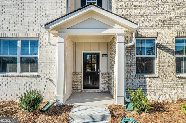 a view of a brick house with chairs
