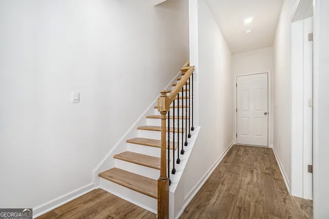 a view of a hallway with wooden floor and entryway