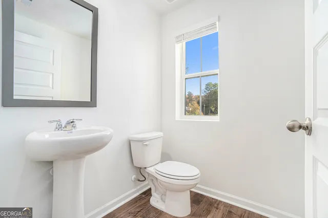 a bathroom with a sink mirror and toilet