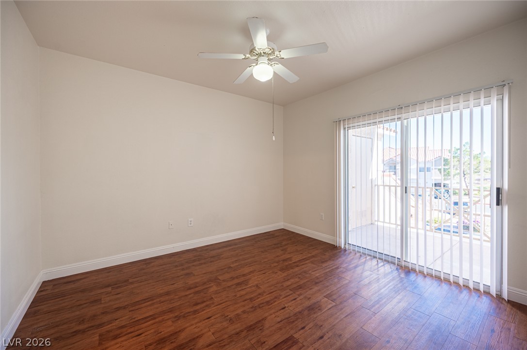 8555 West Russell Road, Unit 2062 Las Vegas, NV 89113 - Photo 20 of 35 Rich hardwood-style flooring extends to the sliding glass doors, opening to a private balcony.