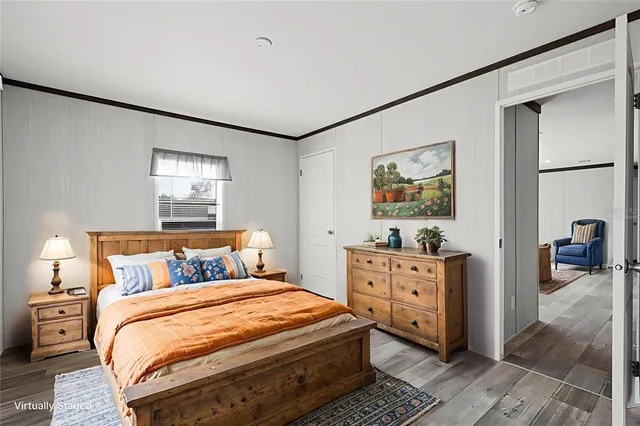 a view of hallway with a large window and wooden floor