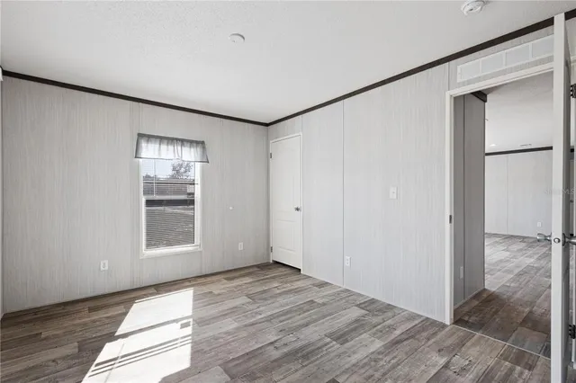 a view of a balcony with wooden floor next to a yard