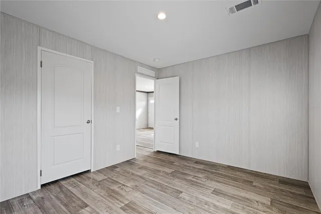 a view of a dry yard with trees